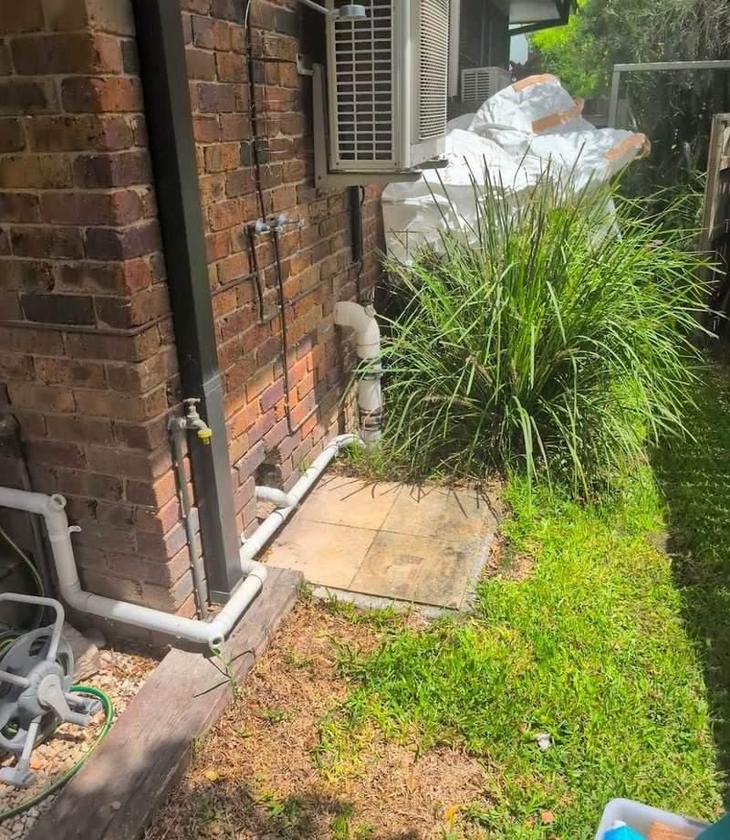 The same side path cleared, with only the paving and garden left